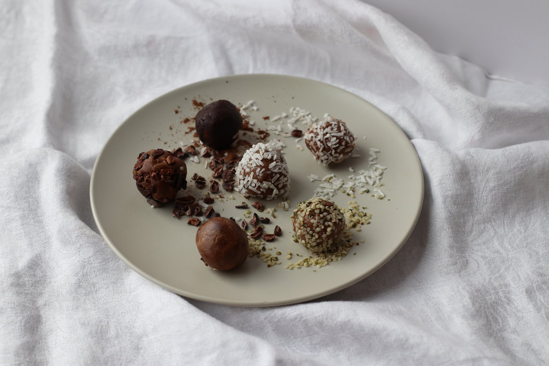 superfood truffle bites on plate with white cloth background
