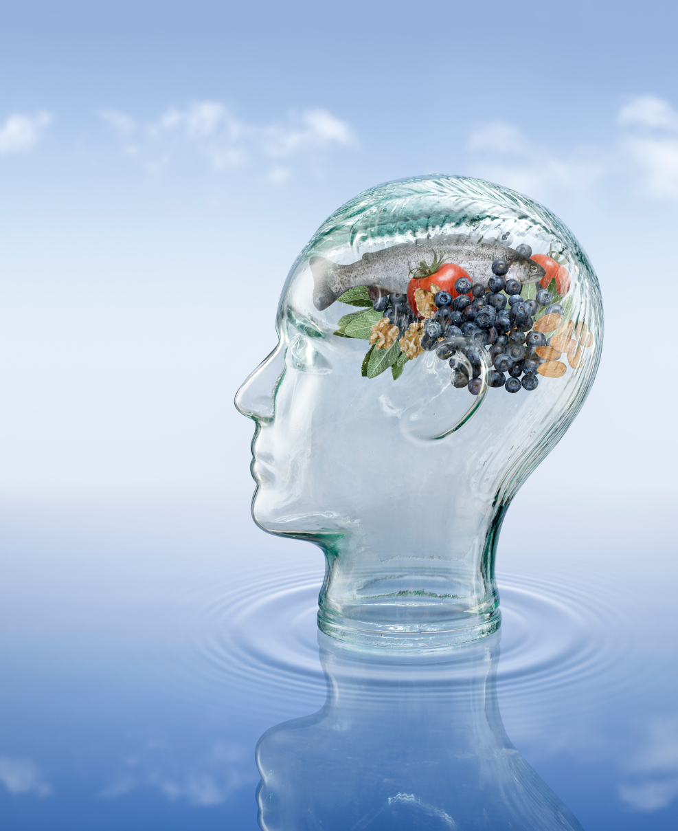 Glass head with stress reducing food inside on water with reflection of clouds