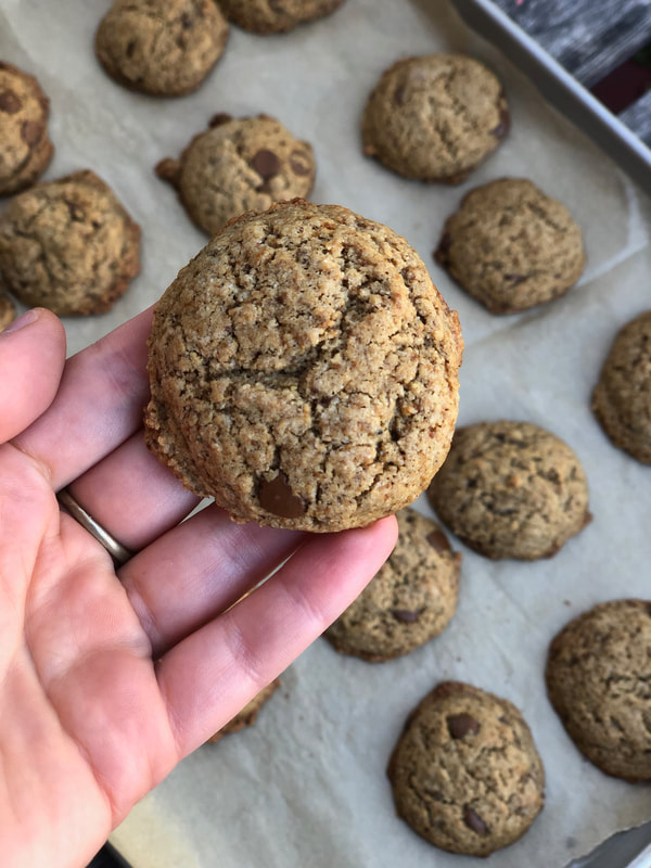 Gluten free vegan carob chip cookies with a hand holding one