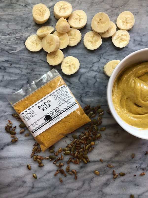 anti-inflammatory golden milk spices in a bag with banana ice cream in a bowl