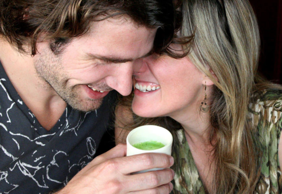 people cuddling closely and laughing while drinking matcha tea
