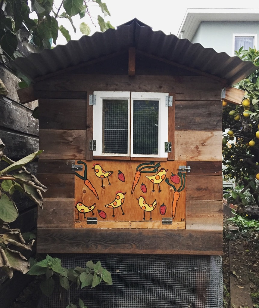chicken coop door painted with vegetables in the shape of chickens