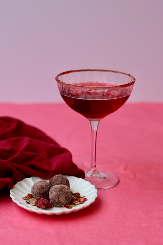 Valentine's day hibiscus margarita and chocolate rose truffled on plate